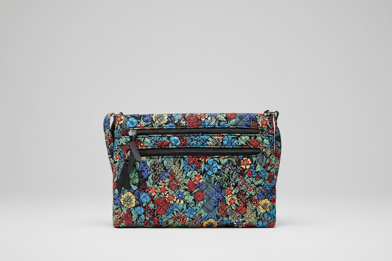 Floral patterned bag with multiple compartments and zippers.